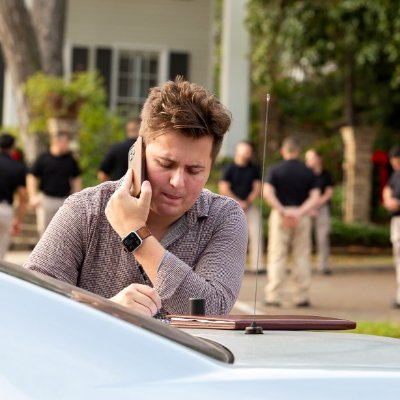 Chase Rogers taking notes while reporting at a scene.